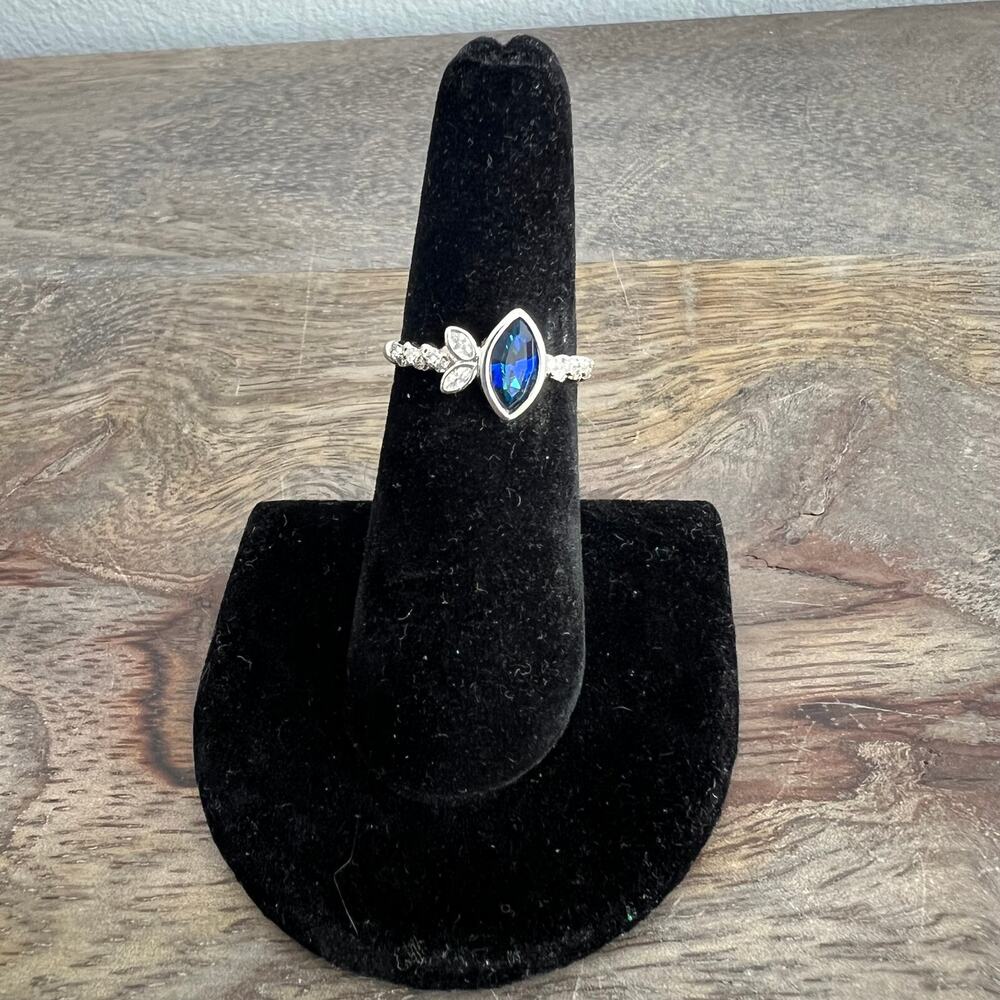 Sapphire blue colored crystal studded elegant ring on silver tone band size 6.25